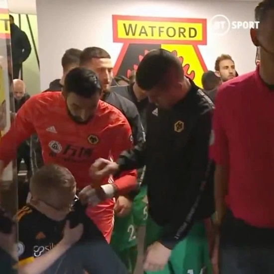 Wolves keeper Rui Patricio wraps shivering young mascot in his coat before Watford loss