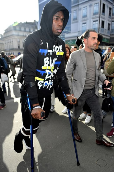 Paul Pogba spotted at Paris fashion week on crutches as Man Utd injury rehab drags on
