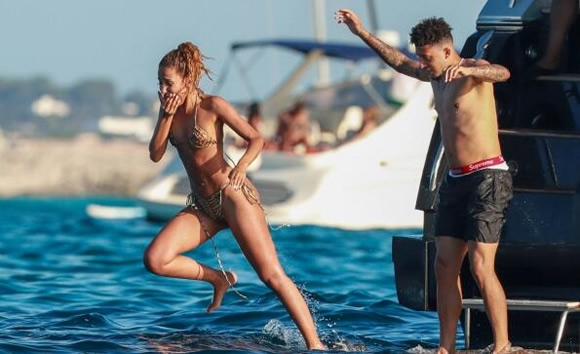 Jadon Sancho enjoys Ibiza break with mystery woman on a yacht as he takes mind off Man Utd transfer talk