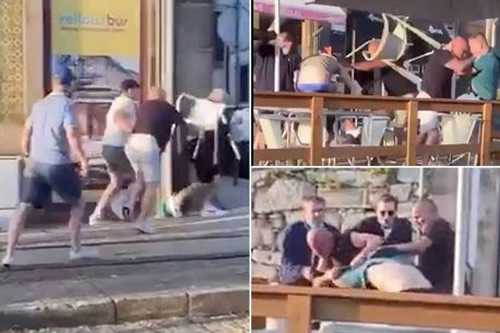 Rival Chelsea and Man City fans filmed launching punches and chairs in bar brawl