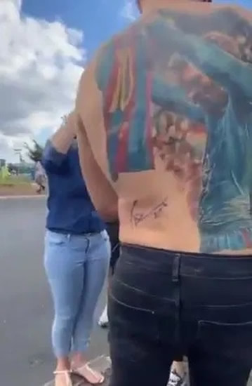 LIONEL MESSI made one superfan's day... by signing his BACK.