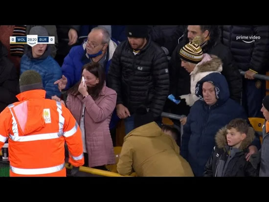 BLEEDING WOLF Wolves fan left with blood pouring down face after having ball smashed into her as crying lad looks on