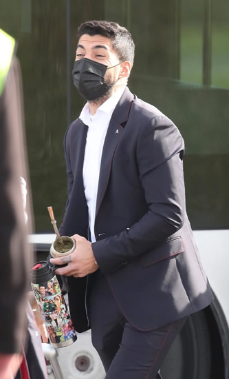 Luis Suarez carries personalised flask with snaps of his family as Atletico star arrives at Lowry before Man Utd clash