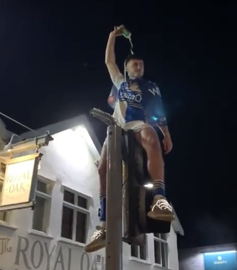 ROVER THE MOON Bristol Rovers star celebrates unbelievable final-day promotion by climbing traffic light and pouring BEER on himself