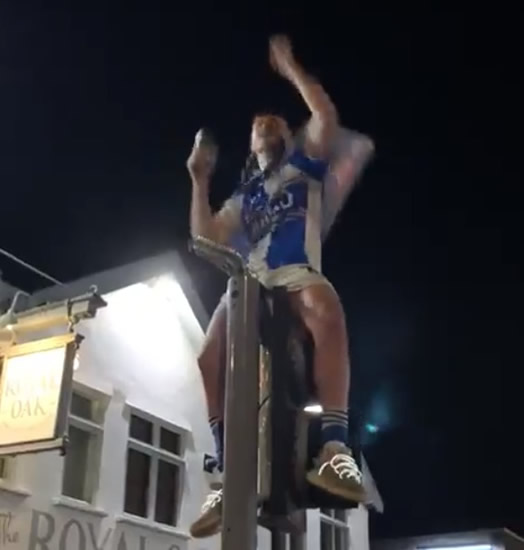 ROVER THE MOON Bristol Rovers star celebrates unbelievable final-day promotion by climbing traffic light and pouring BEER on himself