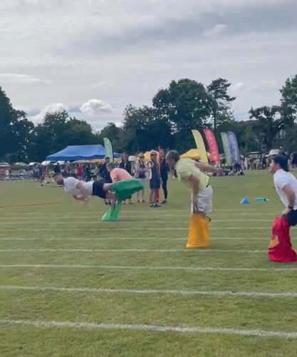 Gary Cahill hilariously flops over finish line in school sports day sack race
