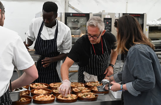 SNACKS OF THE DAY Gary Lineker celebrates his latest spectacular goal — cooking for 300 people at festival