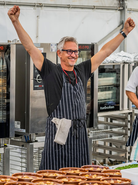 SNACKS OF THE DAY Gary Lineker celebrates his latest spectacular goal — cooking for 300 people at festival