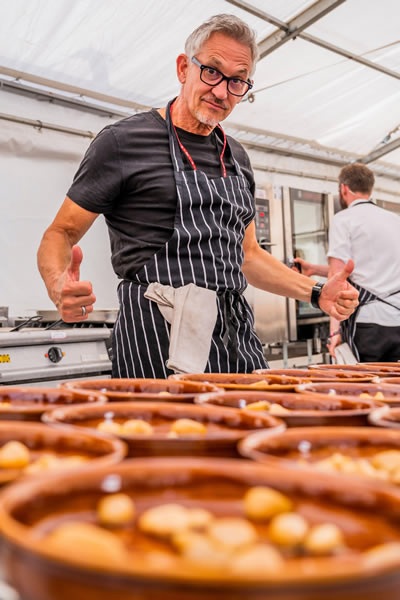 SNACKS OF THE DAY Gary Lineker celebrates his latest spectacular goal — cooking for 300 people at festival