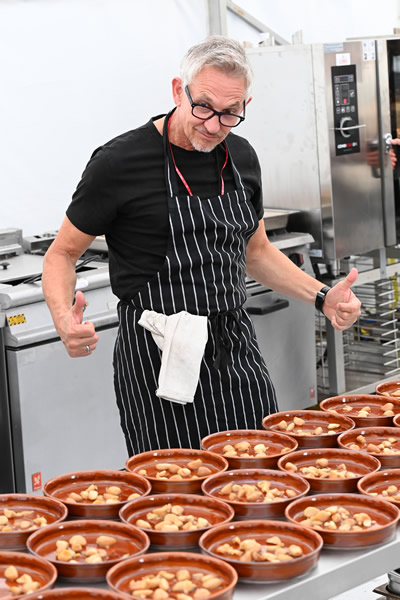 SNACKS OF THE DAY Gary Lineker celebrates his latest spectacular goal — cooking for 300 people at festival