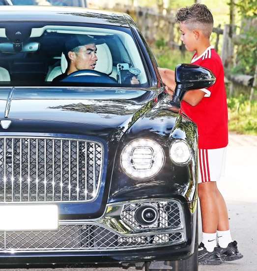 Cristiano Ronaldo signs boy's shirt as he arrives at Man Utd training while agent desperately tries to secure transfer