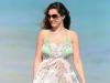 Beach babe ... Kelly covers up in a babydoll dress in Miami