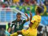 Paul Aguilar of Mexico kicks the ball as Maxim Choupo-Moting of Cameroon defends