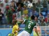 Mexico's Hector Herrera heads the ball against Cameroon's Stephane Mbia, left