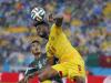 Mexico's Jose Juan Vazquez watches as Cameroon's Alex Song (6) heads the ball during first half