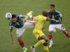 Mexico's Hector Herrera, left, and Mexico's Jose Juan Vazquez, right, fight for the ball with Cameroon's Stephane Mbia
