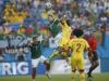 Mexico's Hector Herrera (L) and Cameroon's Stephane Mbia jump for the ball