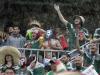 Mexican fans cheer in a downpour