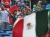 Mexican supporters shout in the rain