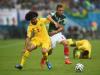 Benoit Assou-Ekotto of Cameroon holds off Paul Aguilar of Mexico