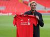 Jurgen Klopp poses with the Liverpool shirt